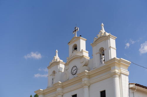 A large white building with a clock on it's side