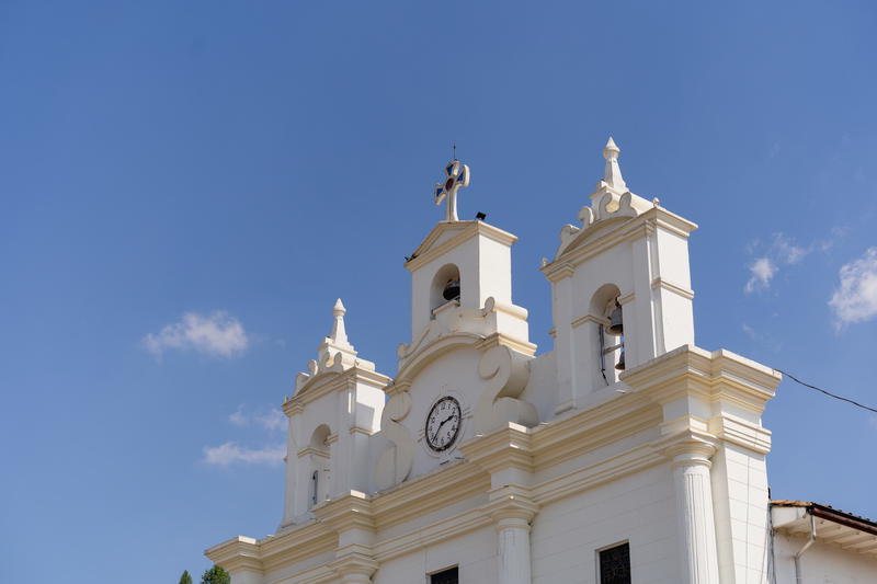A large white building with a clock on it's side