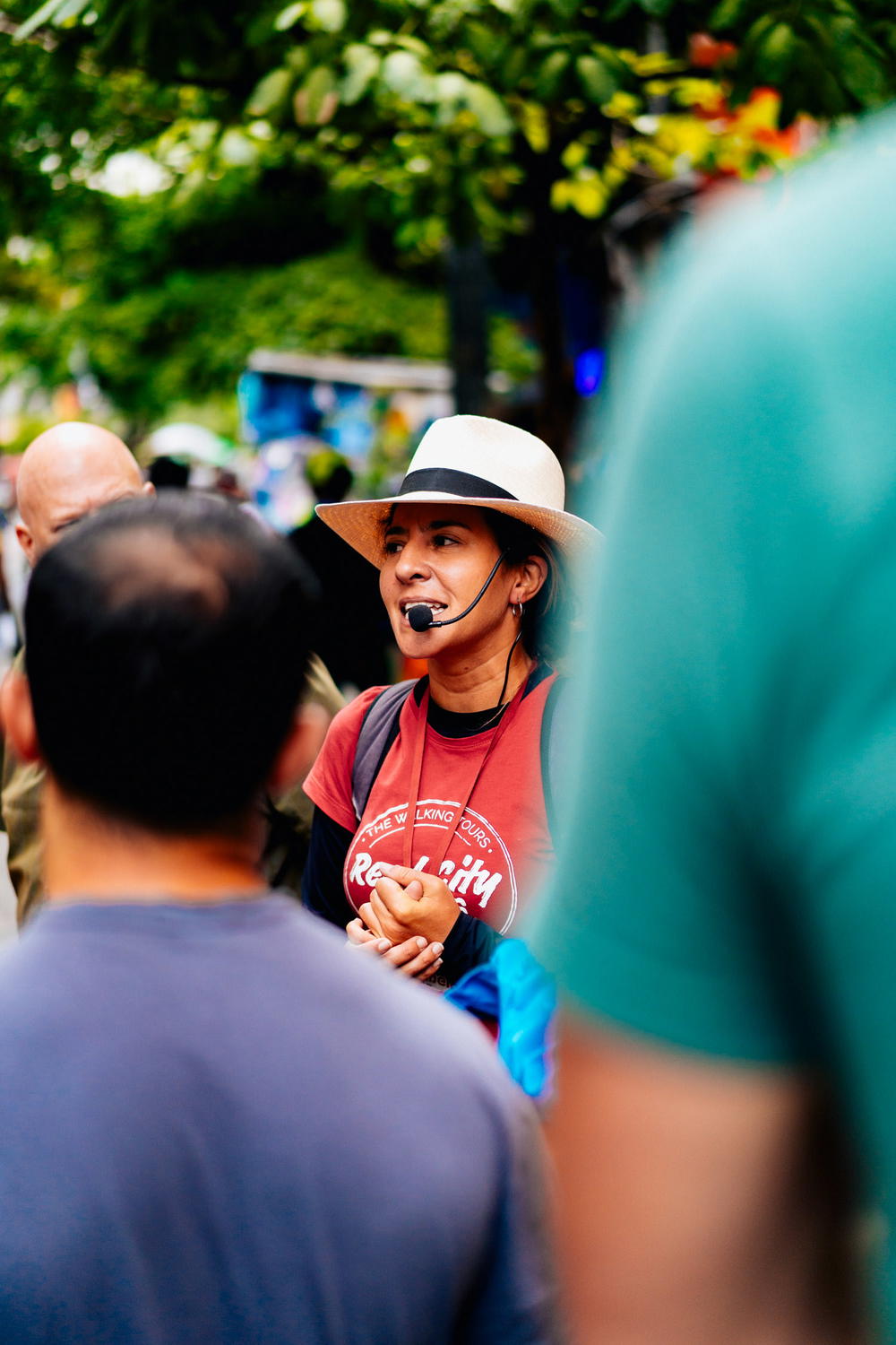 A woman wearing a hat is talking on a cell phone.