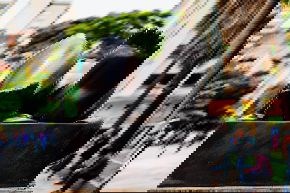 A statue of a person laying down on a sidewalk.