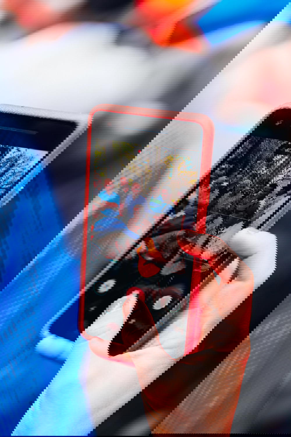 A person taking a picture of a person playing a guitar.