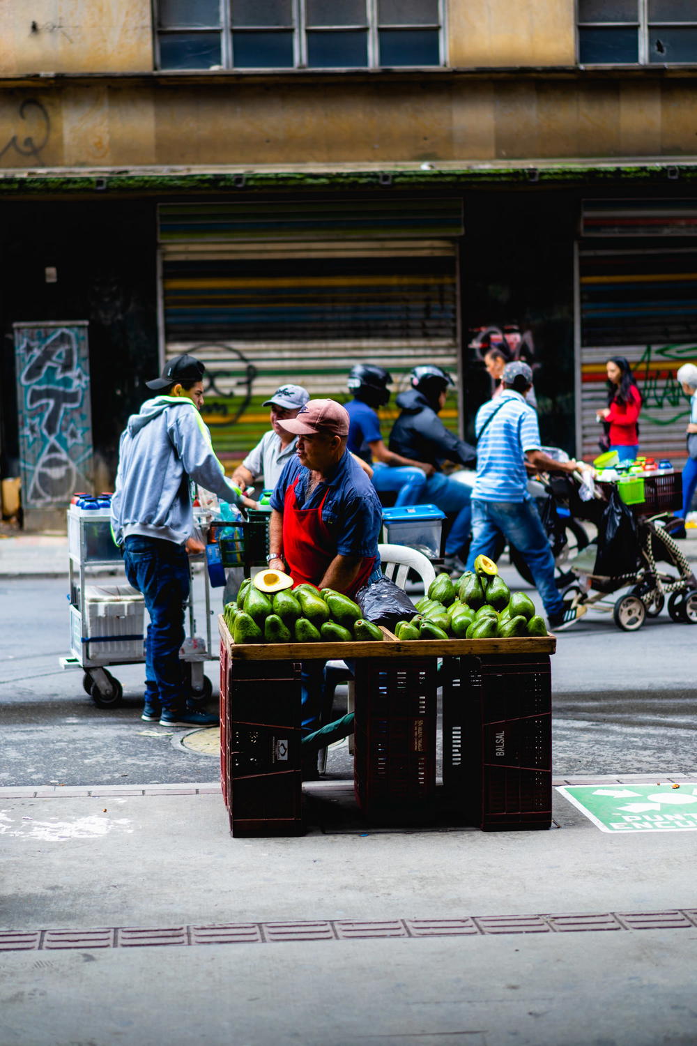 Colombian street vendor selling avocados in Medellin