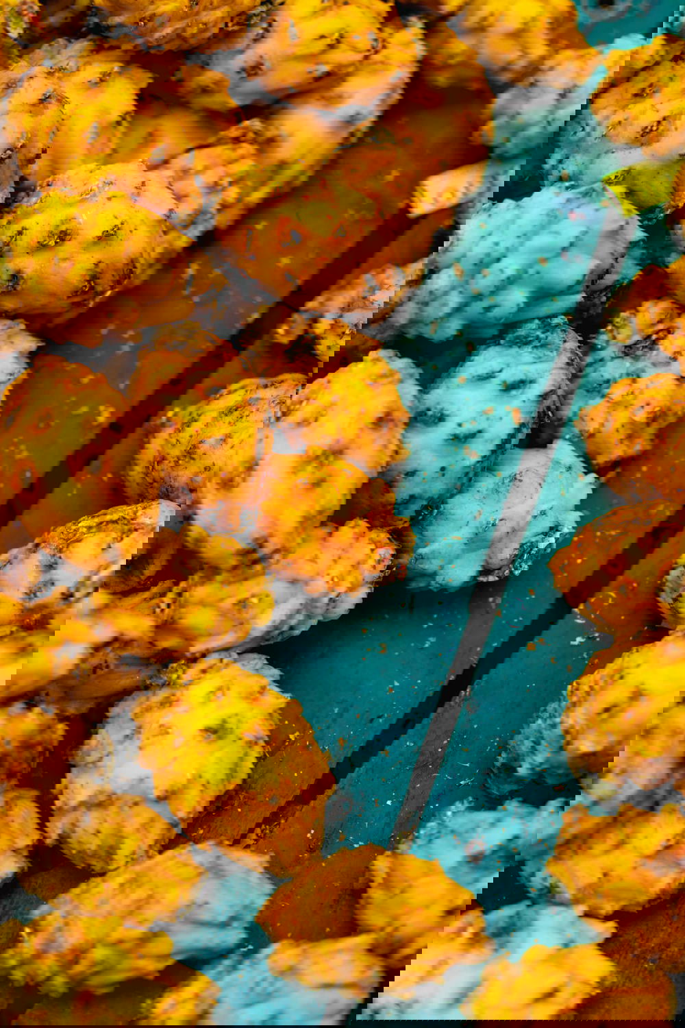 Pitahayas or yellow dragon fruits in a teal wooden box