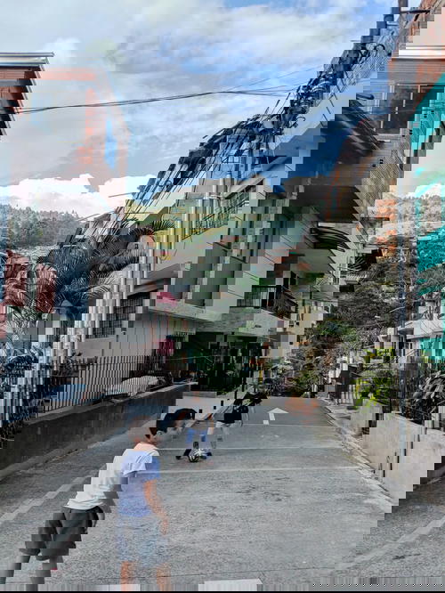 Local children playing on a street in comunas of Medellin near Tranvia route