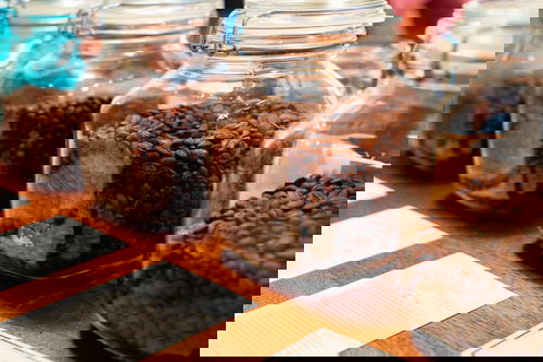Coffee beans in jars on a table.