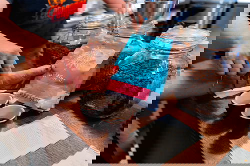 A person pouring coffee into a cup.