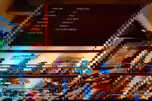 A coffee shop with a sign on the wall.