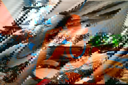 A woman drinking coffee in a coffee shop.