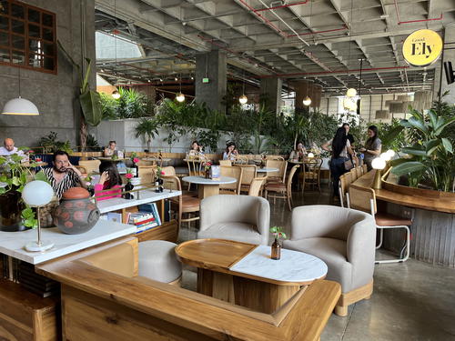 a group of people sitting at tables in a restaurant