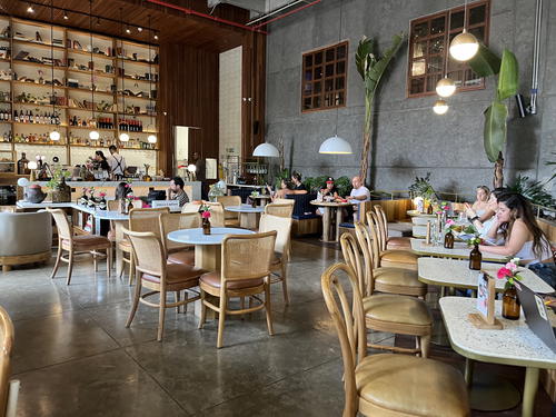 a group of people sitting at tables in a restaurant
