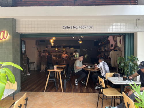 a couple of people sitting at tables in a restaurant