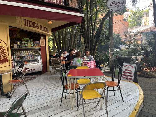 a group of people sitting at a table outside