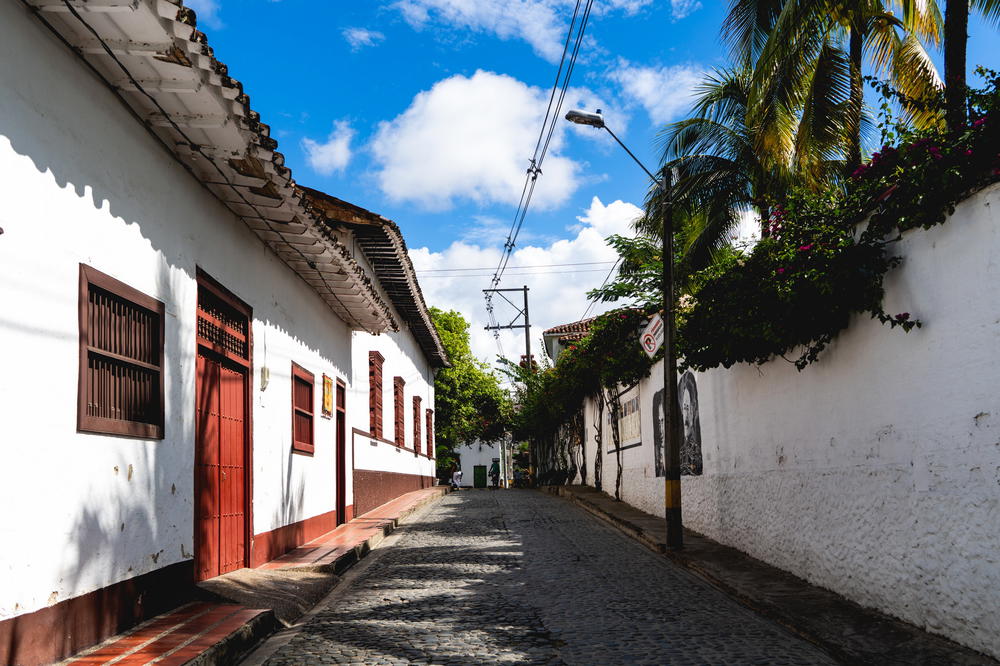 A white building with a red door.