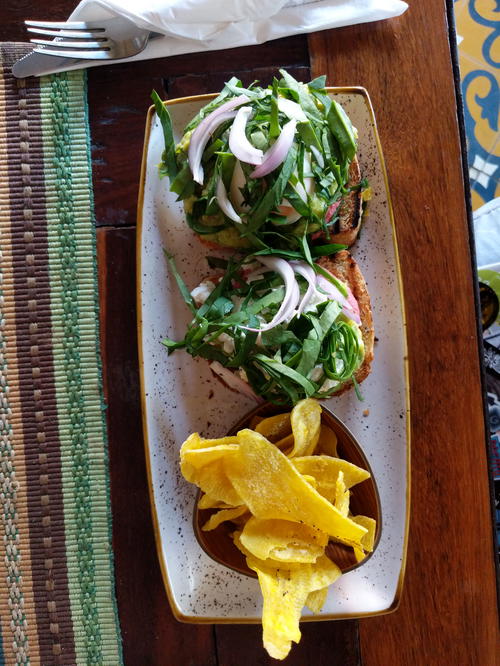 A plate with a sandwich and chips on it.