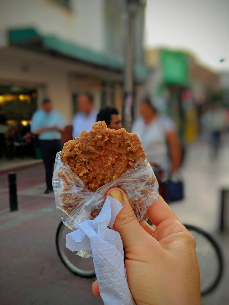 A person holding a piece of food.