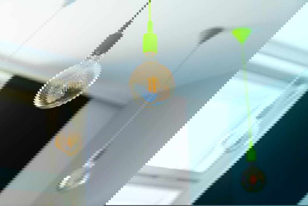 Close-up of a hanging lightbulb in a hotel room interior