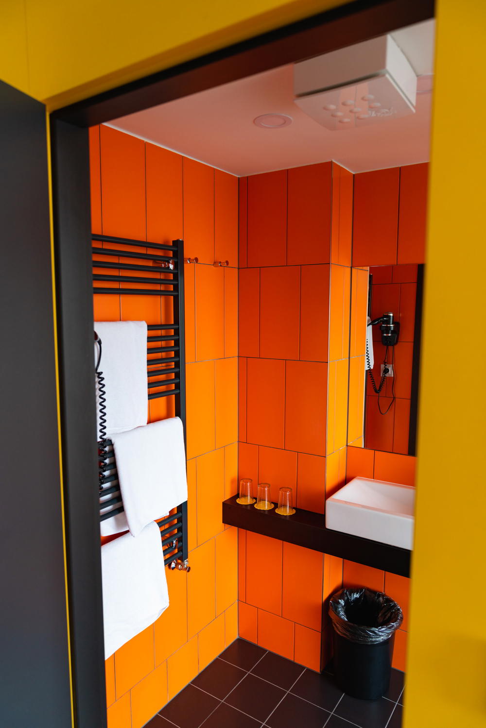 Orange-tiled bathroom at a MeetMe23 hotel room in Prague