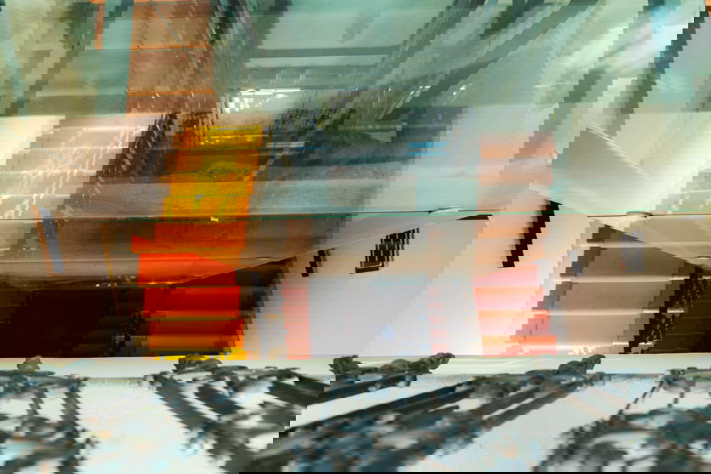 Reflections in the glass elevator at MeetMe23 in Prague