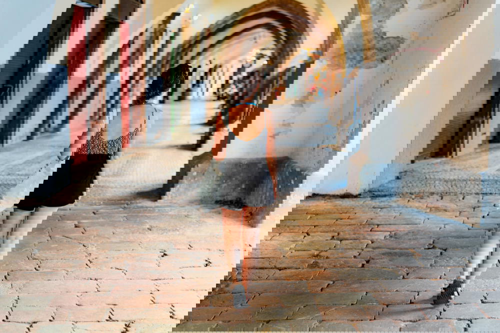 Woman walking in arches in Prague Old City