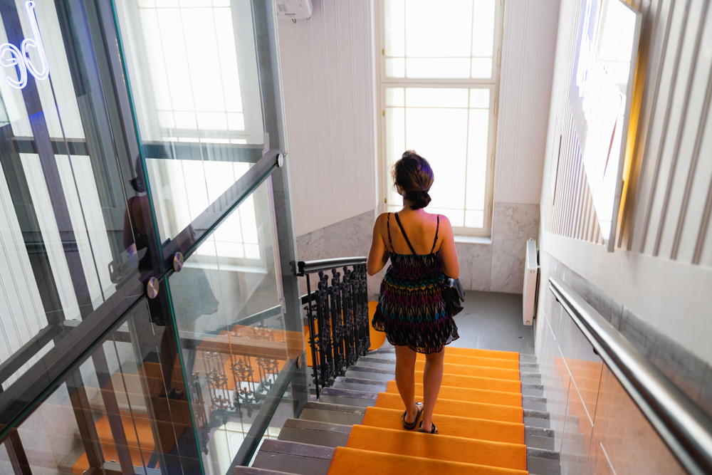 Woman walking down orange carpeted stairs at MeetMe23