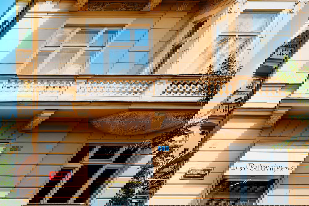 Pastel orange balconies and windows of a historic Vinohrady building