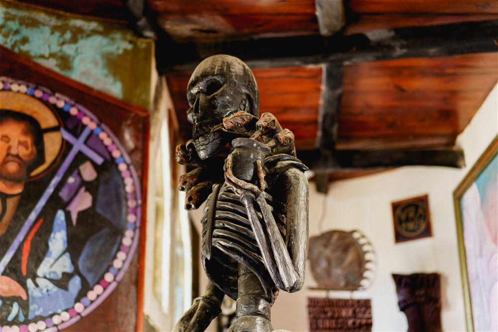 A statue of a skeleton in a church.