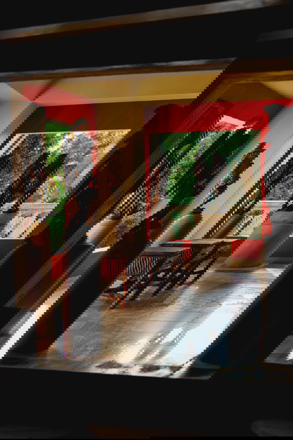 Room full of hand carved Haitian sculptures and statues in an open air room in the Castillo Mundo King mansion of Sosua