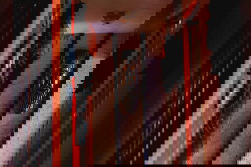 A hallway with a wooden door and a wooden wall.