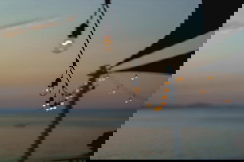 Restaurant tea lights during sunset at Waterfront Bar Playa Alicia in Sosua Dominican Republic