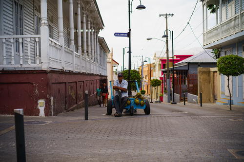 A man riding a bike down a street.