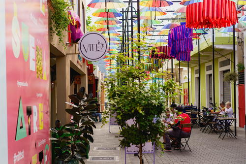 Colorful umbrellas hanging from the ceiling.