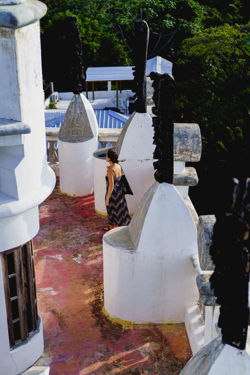 A woman is walking down a white stairway.