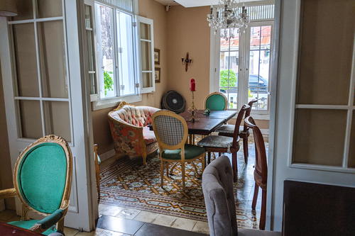 A dining room with a table and chairs.