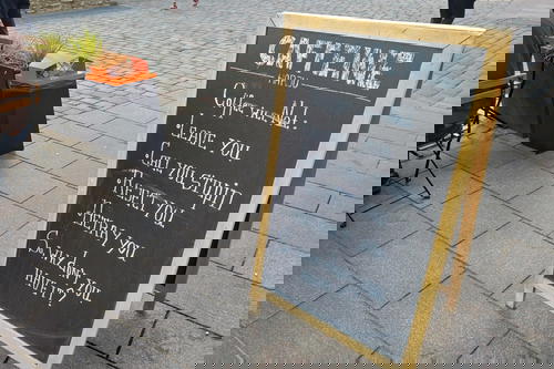A chalkboard with a sign that says caffeine.