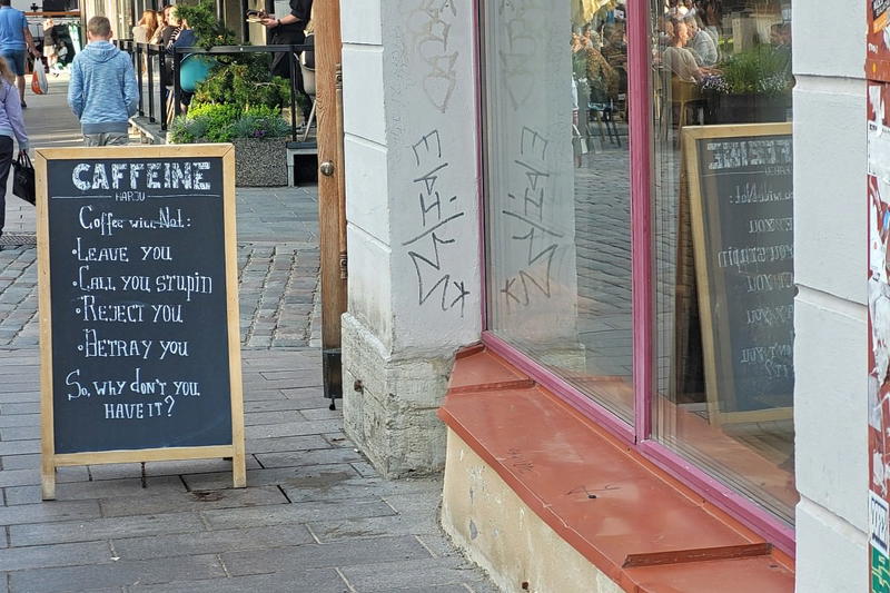 A chalkboard sign on a sidewalk.