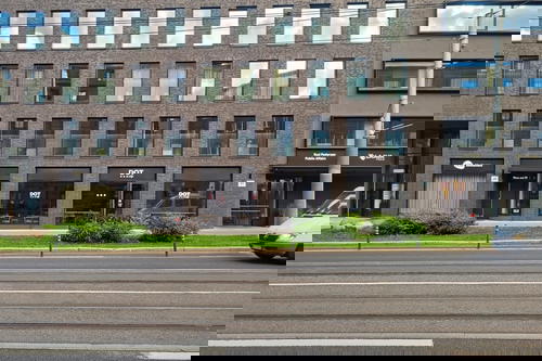 A building with a car parked in front of it.