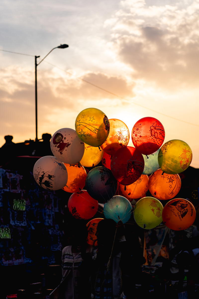A group of balloons at sunset.