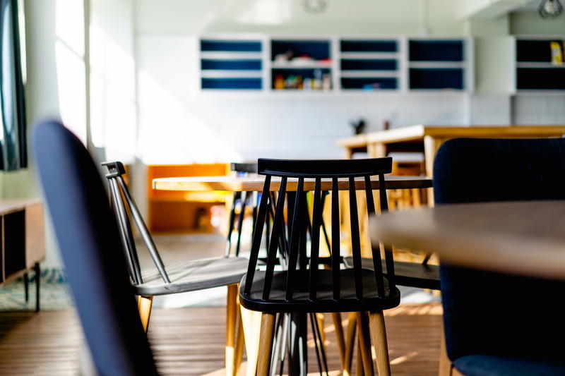 A dining room with a table and chairs.