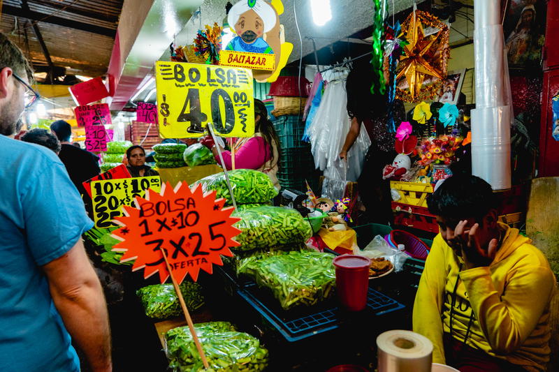 A group of people standing in front of a market.
