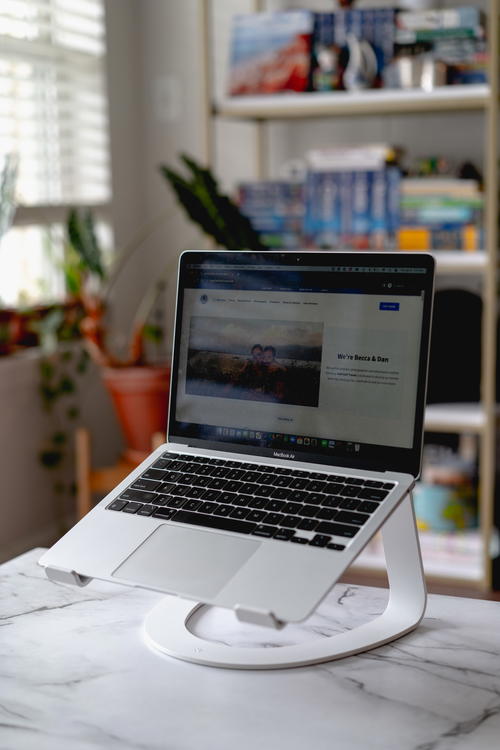 A laptop is sitting on top of a desk.