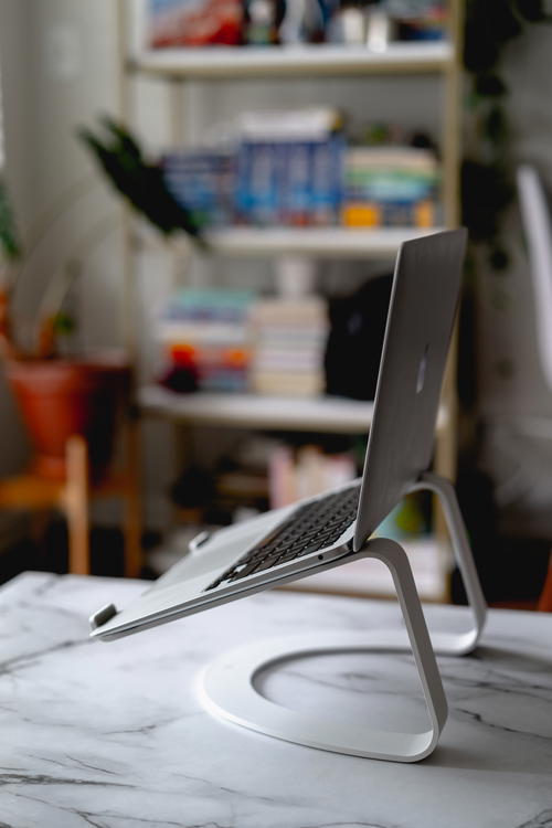A laptop is sitting on a desk in a room.
