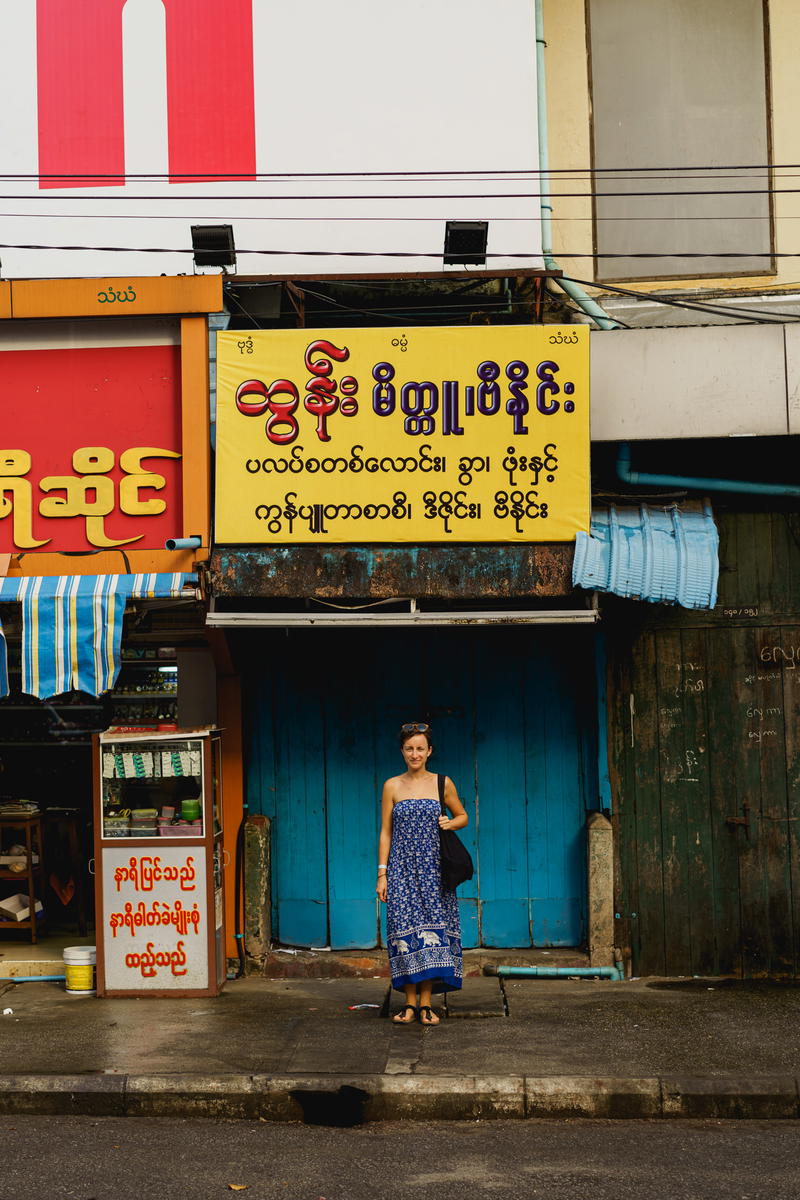 A woman standing in front of a building.