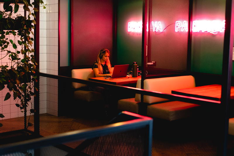 A woman working on her laptop in a restaurant.