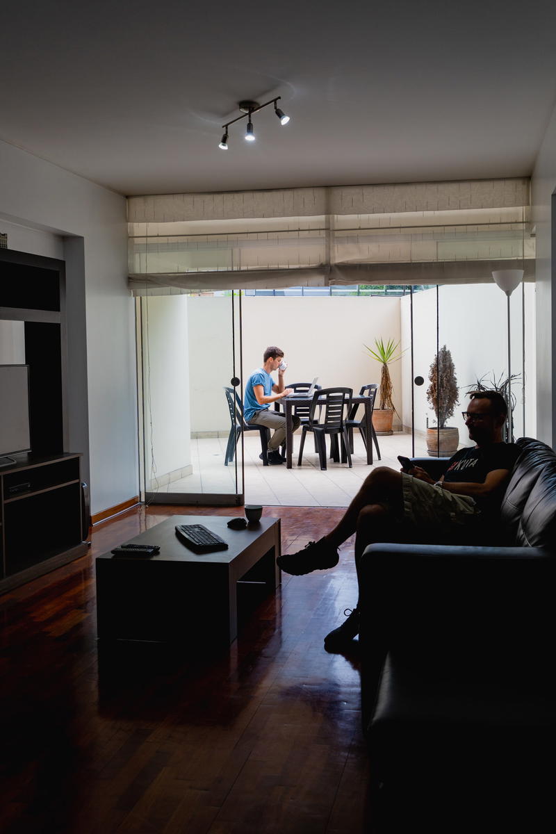 A man sitting on a couch in a living room.
