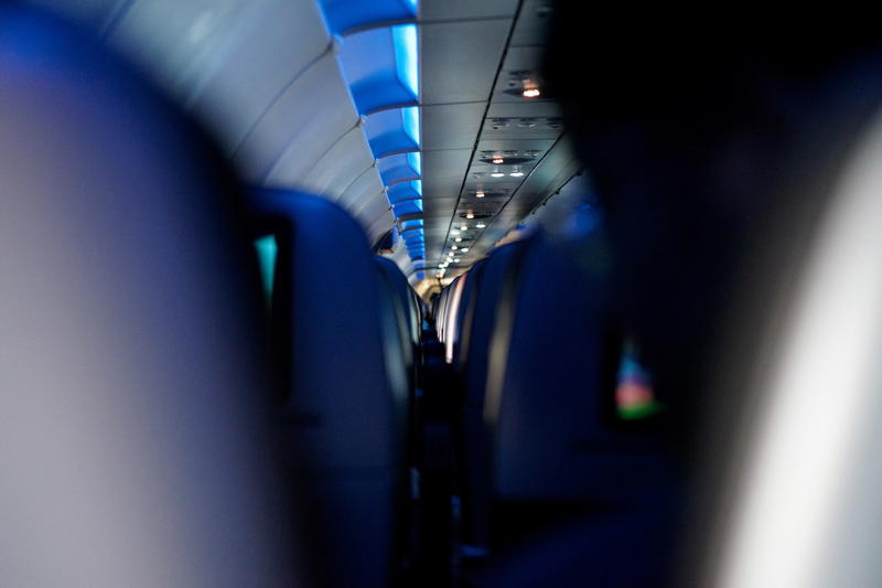 A blurry image of people sitting in an airplane.