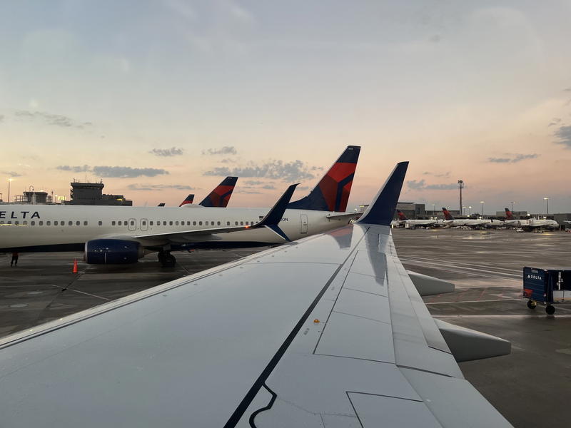 A delta airplane parked on the tarmac.