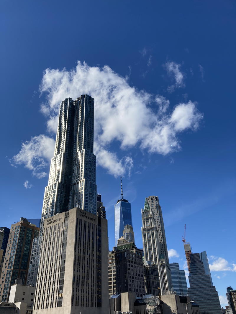 The skyline of new york city with clouds in the sky.