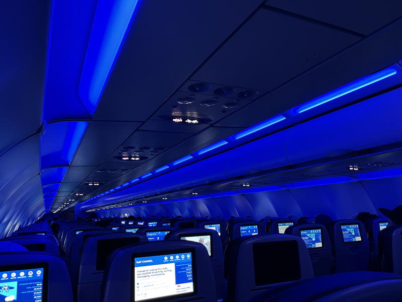 A blue light is shining in the middle of a plane.