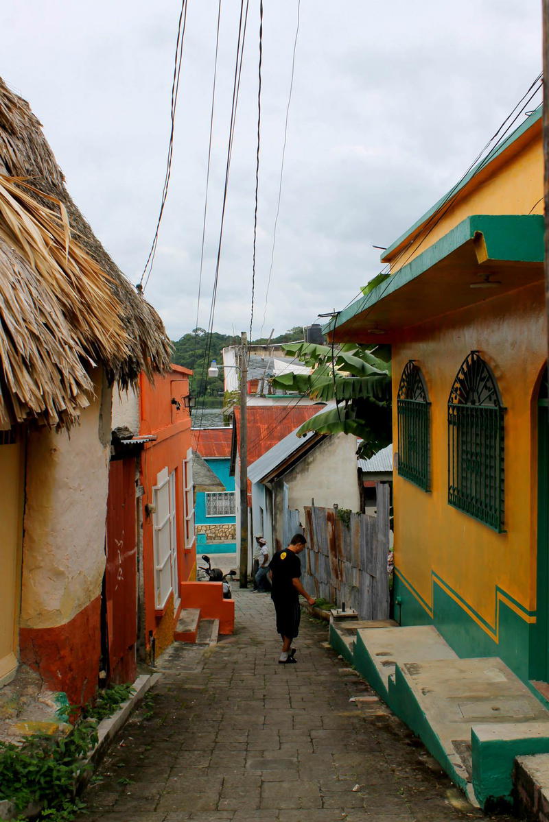 A yellow building with a thatched roof.