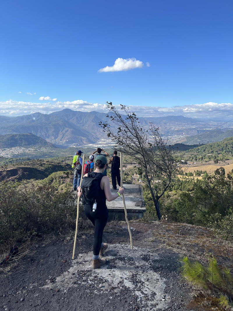 A group of people walking up a hill.